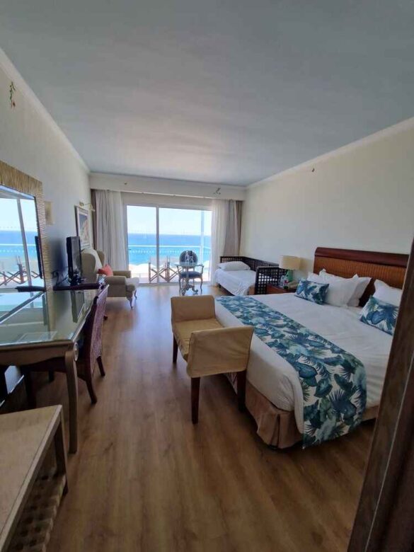 Spacious seaview room at Atrium Prestige with plush king-size bed, private balcony, and breathtaking Aegean Sea views.